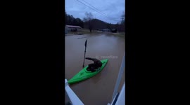 Severe Flooding in Kentucky: Resident Kayaks Through Yard in Gray