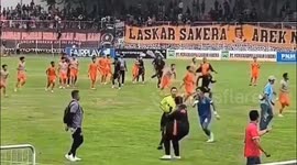 Referee flees as fans invade football pitch to attack players in Indonesia