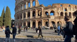 Timelapse of tourists movement with the Colosseum in the background in the afternoon of a bright February day in Rome.