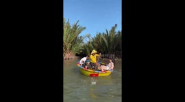 Tourists enjoy the unique and skillful basket boat performance on the river in Vietnam