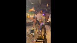 Man's attempt at table dancing leads to a hilarious fall