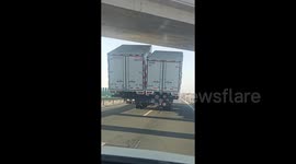 Bizarre moment truck carrying TWO side-by-side containers blocks road in China