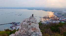 King of the hill! Monkey finds the highest point to sit on cliffs and enjoy view