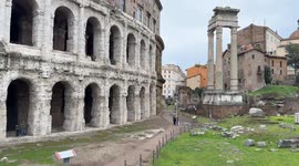 Exterior view of the Teatro Marcello, near the Jewish ghetto, with some tourists visiting on a cloudy December day in Rome.