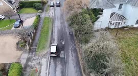 Drone footage shows drivers swerving into oncoming traffic to avoid huge potholes