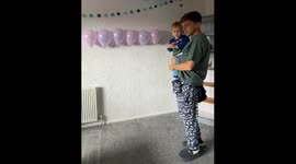 Toddler knocks down balloon display during baby name reveal event