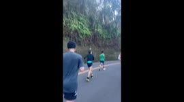 Marathon runner balances pineapple on his head