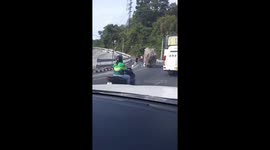 Truck topples backwards as it loses its balance on road in Thailand
