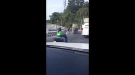 Truck topples backwards as it loses its balance on road in Thailand