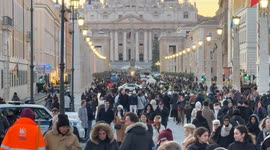 Via della Conciliazione full of people walking and in the background the Basilica of St. Peter on Christmas Day in Rome.