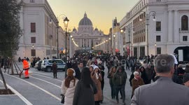 Via della Conciliazione and Piazza Pia full of people walking and in the background the Basilica of St. Peter on Christmas Day in Rome.