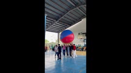 Teachers have awesome school sports day game with giant volleyball