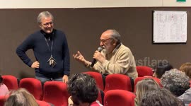Alessandro Haber, actor, director and singer, speaks into the microphone in the audience after watching the film directed by Michele Placido ‘Eterno Visionario’ at the Cinema delle Provincie, a small single-screen community arthouse cinema in Rome.
