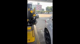 Robot pump attendant helps driver to refill at petrol station in China
