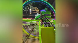 Park-goer rides bicycle round giant hamster wheel