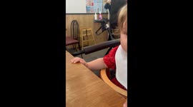 Little girl’s disappointment after tasting healthy greens during dinner with mom