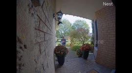 Woman Stumbles While Putting Up Halloween Decorations