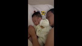 Hush, daddy! Baby covers ears to muffle snoring in China