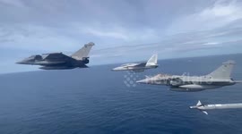 French and Filipino pilots fly alongside each other above Philippine seas