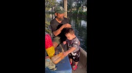 Toddler tucks into bread intended for the fish