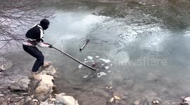 Biker uses tree branch to scoop struggling monkey out of freezing river in China