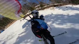 Cat joins owner on parachute-skiing adventure - sporting its very own tiny helmet