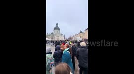 Sweden: In Sweden, a woman holding cross and bible publicly burned the Holy Quran