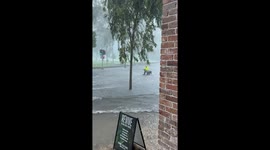 Bicycle Courier Rides Through Flooded to Street to Make Delivery