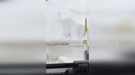 Snow ploughs battle through the fresh powder in New York