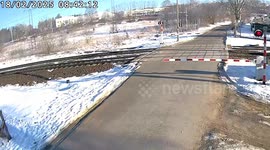 Train hits car that ignored level crossing barrier in Poland