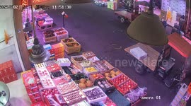 Youngster riding a fruit cart crashes into shop