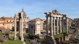 Wide orizontal movement overview of the Roman Forum visited by many tourists on a day with spring temperatures in February in Rome.
