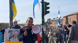 A protester holding an Orthodox Christian crucifix speaks about the persecution in Ukraine against Russian church priests and harshly criticizes Russian Patriarch Kirill for his support for the war during a sit-in to demonstrate against the “Putin regime”