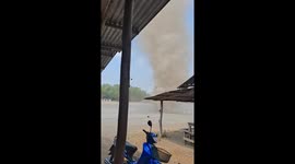 Dust devil tornado rips through factory car park in Thailand