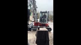 Man pours whiskey soda by intricately operating excavator