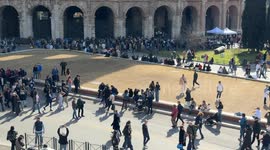Tourists in the Colosseum square without the barriers of the Metro C works and vertical movement on the Colosseum on a clear Sunday in February with spring temperatures in Rome.
