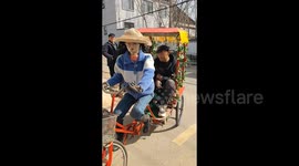 Elderly man in China builds lifelike robot that can ride a bike and transport him around