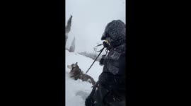 Man and his dog struggle to walk through deep snow in Batumi, Georgia