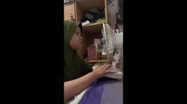 Woman attempts funny trick with mini fan in Surabaya, Indonesia