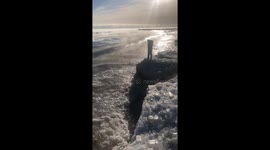 Frozen pants stand upright near the sea in Chicago, USA