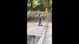 Child nearly falls while walking on uneven ground in Tokyo