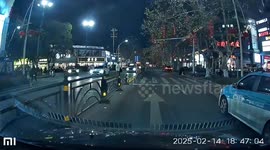 Driver stops as pedestrian trips and falls while crossing the road in Hubei, China