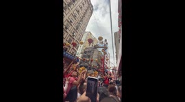 Man uses box to collect money during Chinese New Year blessing in Binondo, Manila, Philippines