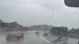 Driver braves windswept rain during commute in Sunol, California, USA