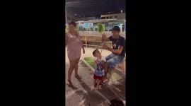 Child playfully misfires roman candle firework in Manaus, Brazil