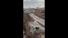 People in costumes of Ratatouille, Santa, and Spider-Man fight beside road in Russia