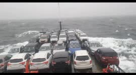 Ship carrying vehicles sways in rough sea but remains secure in Japan