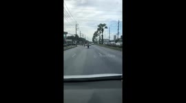 Tourist seen riding motorcycle with king size mattress on the back