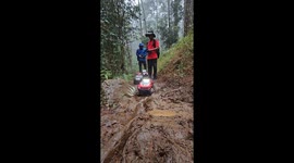 RC jeeps tackle muddy trail during pounding rain