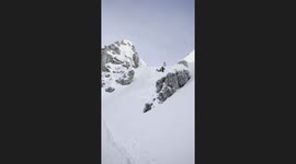 Skier Guides Husky Pack Down Mountain